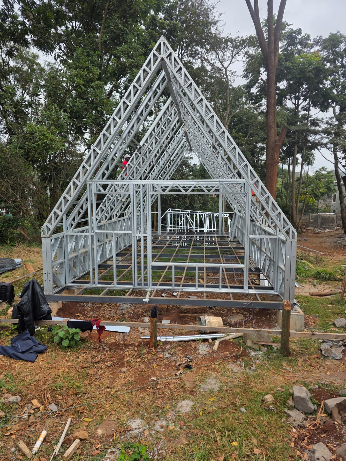 Steel-framed A-Frame viewed from the gable end, with the floor structure and apex trusses in place